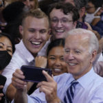 
              President Joe Biden takes a photo with people after speaking at a rally hosted by the Democratic National Committee at Richard Montgomery High School, Thursday, Aug. 25, 2022, in Rockville, Md. (AP Photo/Evan Vucci)
            