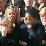 
              FILE - Spectators weep in the crowd along London's Whitehall Saturday Sept. 6, 1997, during the funeral ceremony for Diana, Princess of Wales. It was a warm Saturday evening and journalists had gathered at a Paris restaurant to enjoy the last weekend of summer. At sometime past midnight, phones around the table began to ring all at once. News desks were contacting reporters and photographers to alert them that Princess Diana’s car had crashed in the Pont de l’Alma tunnel in Paris. That's how the news unfolded in the early hours of Aug. 31, 1997. (Jerome Delay/Pool Photo via AP, File)
            