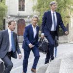 
              Israeli diamond magnate Beny Steinmetz, center, with his lawyers Christian Luescher, left, and Daniel Kinzer arrives to a courthouse in Geneva, Switzerland, Monday, Aug. 29, 2022. Steinmetz returns to a Geneva courthouse on Monday to appeal his conviction on charges of corrupting foreign public officials and forging documents, a case linked to his firm's bid to reap lavish iron ore resources in the west African country of Guinea. (Salvatore Di Nolfi/Keystone via AP)
            