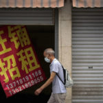 
              A man wearing a face mask walks by a banner that reads "Prosperous shop for rent" hangs on a vacant shop lot in Beijing, Wednesday, Aug. 17, 2022. Factories in China's southwest have shut down after reservoirs used to generate hydropower ran low in a worsening drought, adding to economic strains at a time when President Xi Jinping is trying to extend his position in power. (AP Photo/Andy Wong)
            