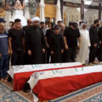 
              In this frame grab from video, people pray next to Iraqi flag-draped coffins of two fighters who were killed in clashes with Iraqi security forces in Baghdad's Green Zone, at the Imam Ali Shrine during their funeral, in Najaf, Iraq, Tuesday, Aug. 30, 2022. The fighters were among at least 30 people who have died in two days of unrest, according to officials. Those backing cleric Muqtada al-Sadr, who resigned suddenly Monday amid a political impasse, earlier stormed the Green Zone, once the stronghold of the U.S. military that's now home to Iraqi government offices and foreign embassies. (AP Photo)
            