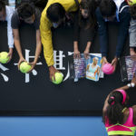 
              FILE - Serena Williams of the U.S. signs autographs for fans after defeating Garbine Muguruza of Spain in their fourth round match at the Australian Open tennis championship in Melbourne, Australia, Monday, Jan. 26, 2015. After nearly three decades in the public eye, few can match Serena Williams' array of accomplishments, medals and awards. Through it all, the 23-time Grand Slam title winner hasn't let the public forget that she's a Black American woman who embraces her responsibility as a beacon for her people. (AP Photo/Rob Griffith, File)
            