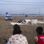 
              People look at the wreckage from a plane crash at Watsonville Municipal Airport in Watsonville, Calif., Thursday, Aug. 18, 2022. (AP Photo/Nic Coury)
            