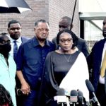 
              Wanda Cooper-Jones and Marcus Arbery, the parents of Ahmaud Arbery, are flanked by Rev. Jesse Jackson and Attorney Lee Merritt while addressing the media following the sentencing of Travis McMicheal in federal court in Brunswick, Ga. on Monday, Aug. 8, 2022. The white man who fatally shot Arbery after chasing the 25-year-old Black man in a Georgia neighborhood was sentenced Monday to life in prison for committing a federal hate crime. (AP Photo/Lewis M. Levine)
            