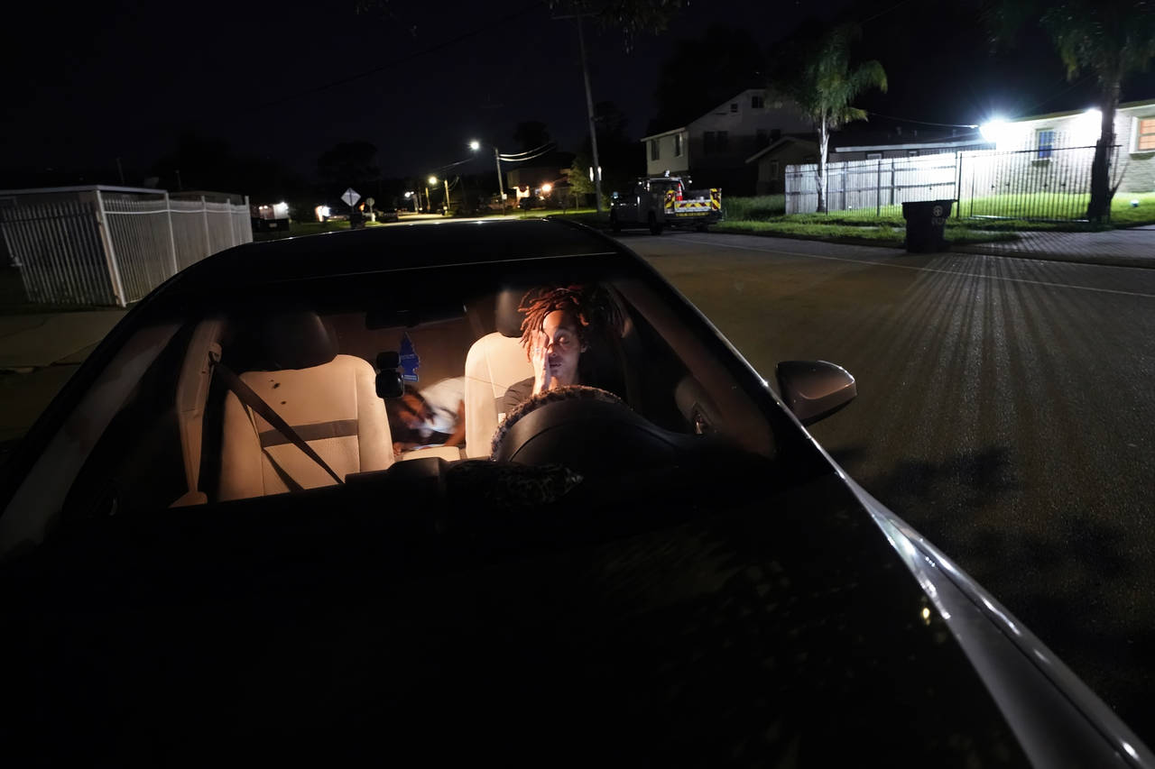 Jada Riley sits in her car at night with her son Jayden Harris, 6, as she contemplates where she mi...