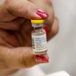 
              A nurse holds a vial containing the monkeypox vaccine at a vaccination clinic run by the Mecklenburg County Public Health Department in Charlotte, N.C., Saturday, Aug. 20, 2022. (AP Photo/Nell Redmond)
            
