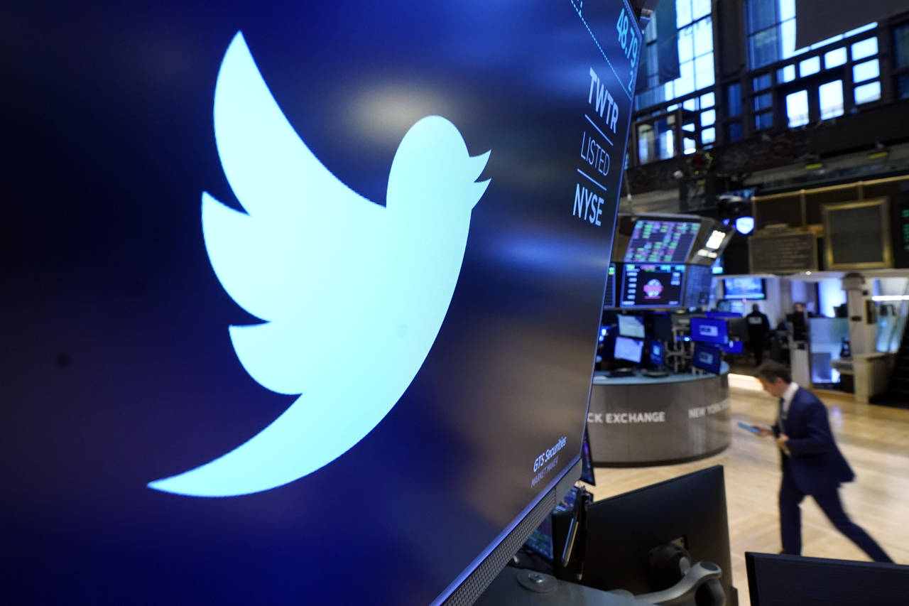 FILE - The logo for Twitter appears above a trading post on the floor of the New York Stock Exchang...