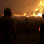 
              Firefighters work to stop a wildfire in Gouveia, in the Serra da Estrela mountain range, in Portugal on Thursday, Aug. 18, 2022. Authorities in Portugal said Thursday they had brought under control a wildfire that for almost two weeks raced through pine forests in the Serra da Estrela national park, but later in the day a new fire started and threatened Gouveia. (AP Photo/Joao Henriques)
            