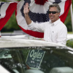 
              Andy Ogles, a candidate in Tennessee's 5th Congressional District Republican primary, waves to drivers arriving at a voting location Thursday, Aug. 4, 2022, in Brentwood, Tenn. (AP Photo/Mark Humphrey)
            