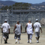 
              FILE - Inmates walk the exercise yard at the California Medical Facility in Vacaville, Calif., June 20, 2018. California would allow more ill and dying inmates to be released from state prisons under legislation that cleared the state Senate and heads to the Assembly for final approval. (AP Photo/Rich Pedroncelli, File)
            