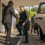 
              Secretary of State Antony Blinken, center, is greeted by Rwanda's Minister of Foreign Affairs Vincent Biruta, left, as he arrives to meet with Rwandan President Paul Kagame at the President's Office in Urugwiro Village in Kigali, Rwanda, Thursday, Aug. 11, 2022. Blinken is on a ten day trip to Cambodia, Philippines, South Africa, Congo, and Rwanda. (AP Photo/Andrew Harnik, Pool)
            