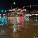 
              FILE - In this photo courtesy of City of Moab, vehicles navigate high waters at the intersection of South Main Street and 100 South in Moab, Utah, Aug. 20, 2022. Jetal Agnihotri, a 29-year-old from Tucson, Ariz., was still missing Monday, Aug. 22, 2022, after being swept away at Utah's Zion National Park three days earlier as flooding surged through the southwestern United States and imperiled tourists visiting the region's scenic parks. (Rani Derasary/City of Moab via AP, File)
            