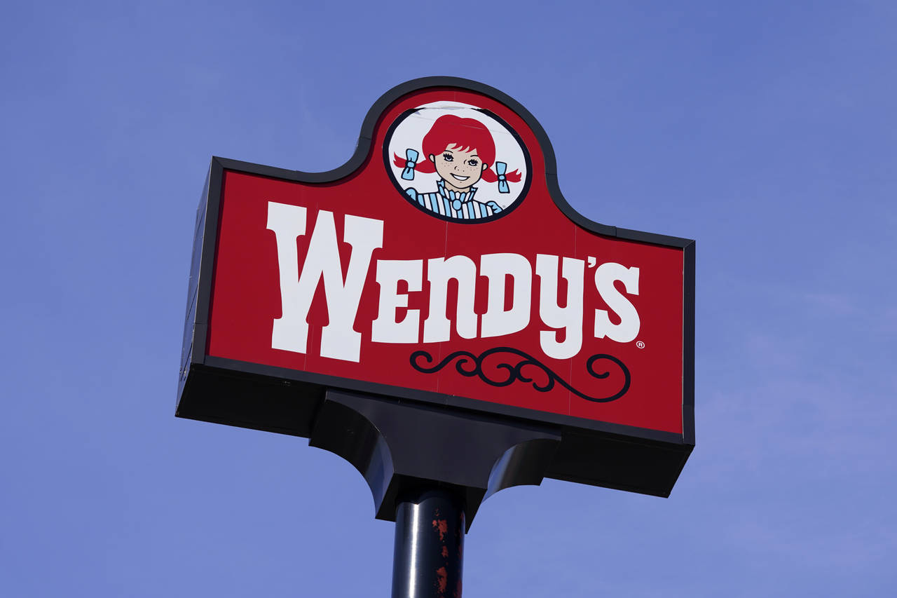 FILE - This Thursday, Feb. 25, 2021, photo shows a sign over a Wendy's restaurant in Des Moines, Io...