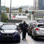 
              A police officer arrives on scene where a shooting occurred, Monday, Aug. 22, 2022, at a condominium in Atlanta. (AP Photo/Brynn Anderson)
            