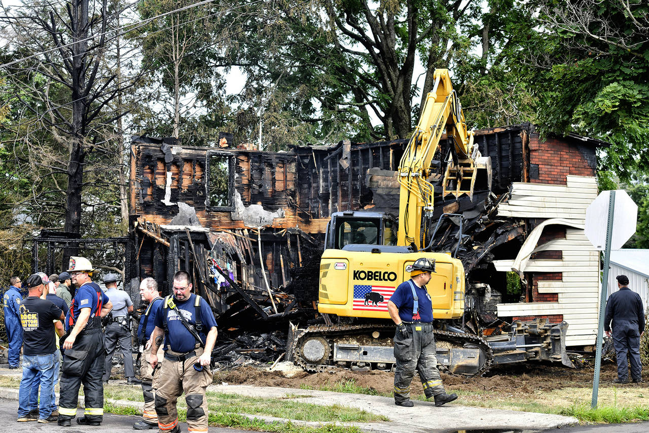 Crews work to demolish a house that was destroyed by a fatal fire on the 700 block of 1st Street in...