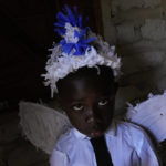 A boy dressed up as an angel in the Emperor's procession poses for a photo in the Kalunga quilombo during the culmination of the week-long pilgrimage and celebration for the patron saint "Nossa Senhora da Abadia" or Our Lady of Abadia, in the rural area of Cavalcante in Goias state, Brazil, Monday, Aug. 15, 2022. Devotees, who are the descendants of runaway slaves, celebrate Our Lady of Abadia at this time of the year with weddings, baptisms and by crowning distinguished community members, as they maintain cultural practices originating from Africa that mix with Catholic traditions. (AP Photo/Eraldo Peres)