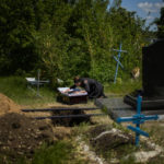 
              FILE - Iuliia Loseva cries over the coffin of her husband Volodymyr Losev, 38, during his funeral at a cemetery in Zorya Truda, Odesa region, Ukraine, Monday, May 16, 2022. Volodymyr Losev, a Ukrainian volunteer soldier, was killed on May 7 when the military vehicle he was driving ran over a mine in eastern Ukraine. (AP Photo/Francisco Seco, File)
            