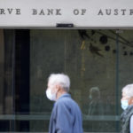 
              A couple walks past the Reserve Bank of Australia in Sydney on Tuesday, Aug. 2, 2022. Australia’s central bank on Tuesday boosted its benchmark interest rate for a fourth consecutive month to a six-year high of 1.85%. (AP Photo/Rick Rycroft)
            
