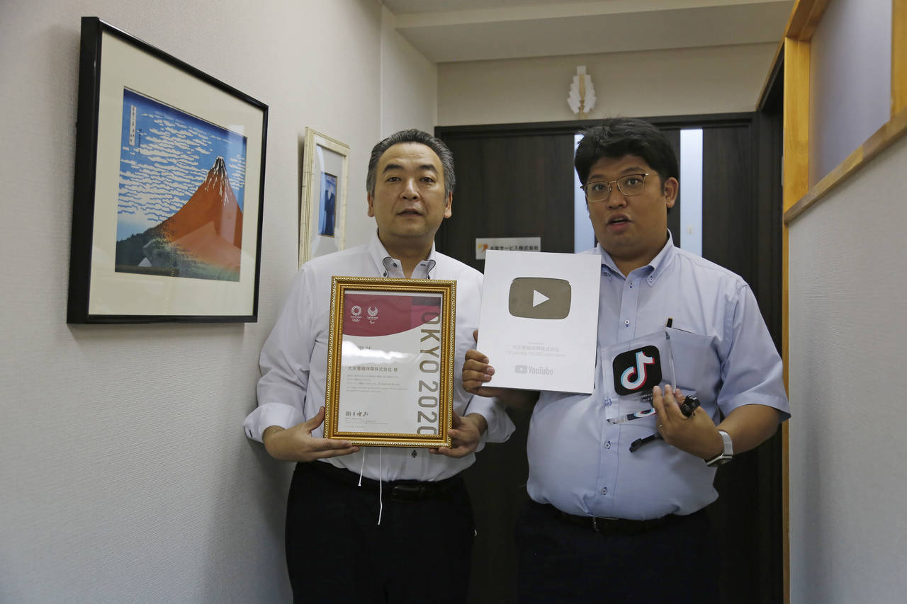 Daikyo Security Chief Executive Daisuke Sakurai, right, and General Manager Tomohiko Kojima hold th...