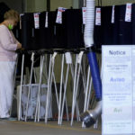 
              A voter fills out her ballot at a polling station inside the Indian Creek Fire Station during the primary election, Tuesday, Aug. 23, 2022, in Miami Beach, Fla. (AP Photo/Wilfredo Lee)
            