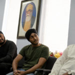 
              Kulwinder Singh Soni sits, center, sits with members of his family in the office space of Guru Nanak Darbar of Long Island, a Sikh gurudwara, Wednesday, Aug. 24, 2022, in Hicksville, N.Y. Their Afghan Sikh family of 13 has found refuge in the diaspora community on Long Island where the Sikh community is helping family members obtain work permits, housing, healthcare and find schools for the children. (AP Photo/John Minchillo)
            