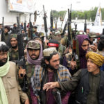 
              Taliban fighters celebrate one year since they seized the Afghan capital, Kabul, in front of the U.S. Embassy in Kabul, Afghanistan, Monday, Aug. 15, 2022. The Taliban marked the first-year anniversary of their takeover after the country's western-backed government fled and the Afghan military crumbled in the face of the insurgents' advance. (AP Photo/Ebrahim Noroozi)
            