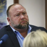 
              Conspiracy theorist Alex Jones attempts to answer questions about his emails asked by Mark Bankston, lawyer for Neil Heslin and Scarlett Lewis, during trial at the Travis County Courthouse in Austin, Wednesday Aug. 3, 2022. Jones testified Wednesday that he now understands it was irresponsible of him to declare the Sandy Hook Elementary School massacre a hoax and that he now believes it was “100% real." (Briana Sanchez/Austin American-Statesman via AP, Pool)
            