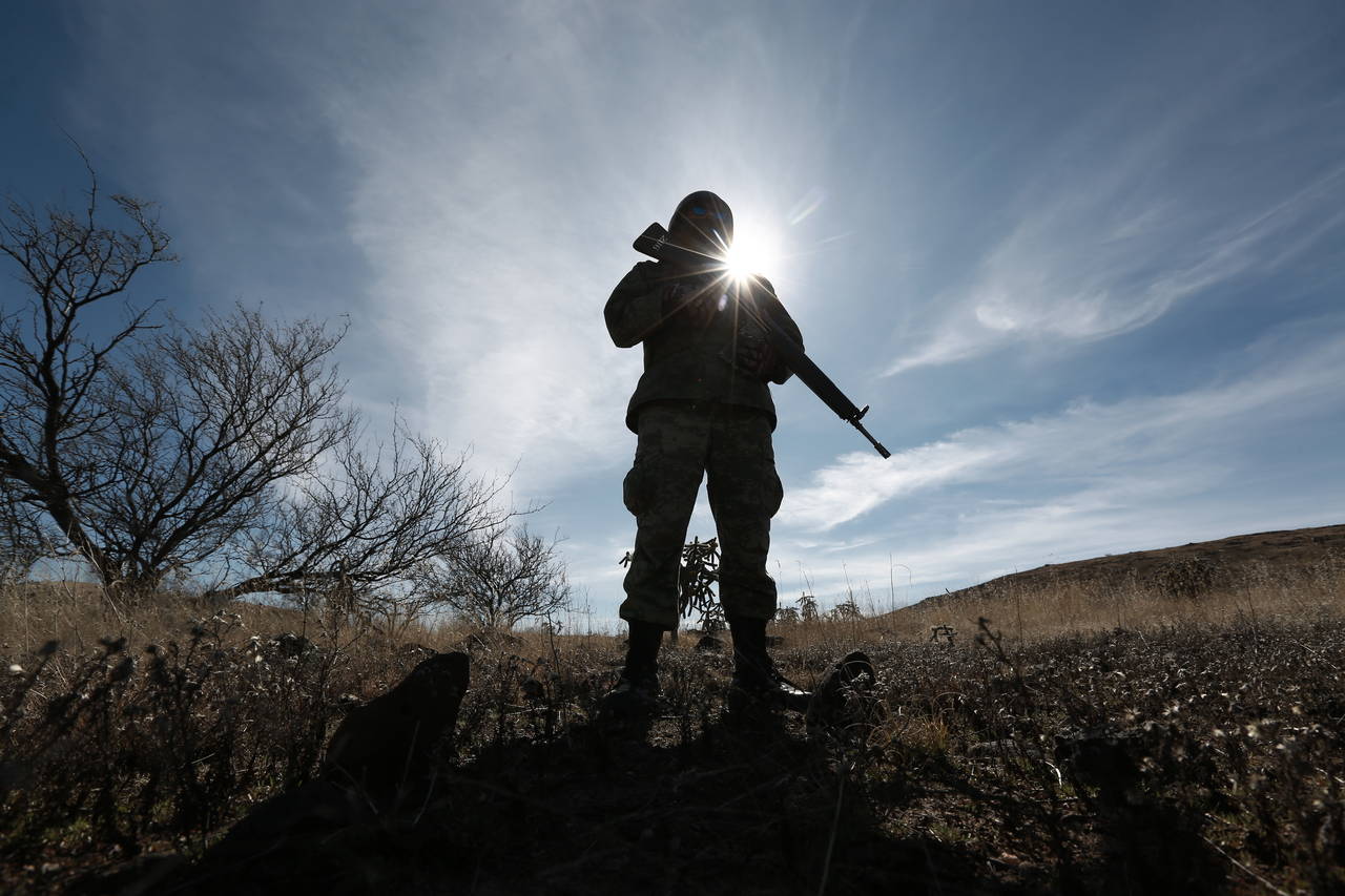 FILE - A National Guards soldier stands guard near Bavispe, Sonora state, Mexico, where family memb...