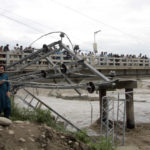
              Damaged electrical towers on the ground after being damaged during the floods in Mingora, the capital of Swat valley in Pakistan, Saturday, Aug. 27, 2022. Officials say flash floods triggered by heavy monsoon rains across much of Pakistan have killed nearly 1,000 people and displaced thousands more since mid-June. (AP Photo/Naveed Ali)
            