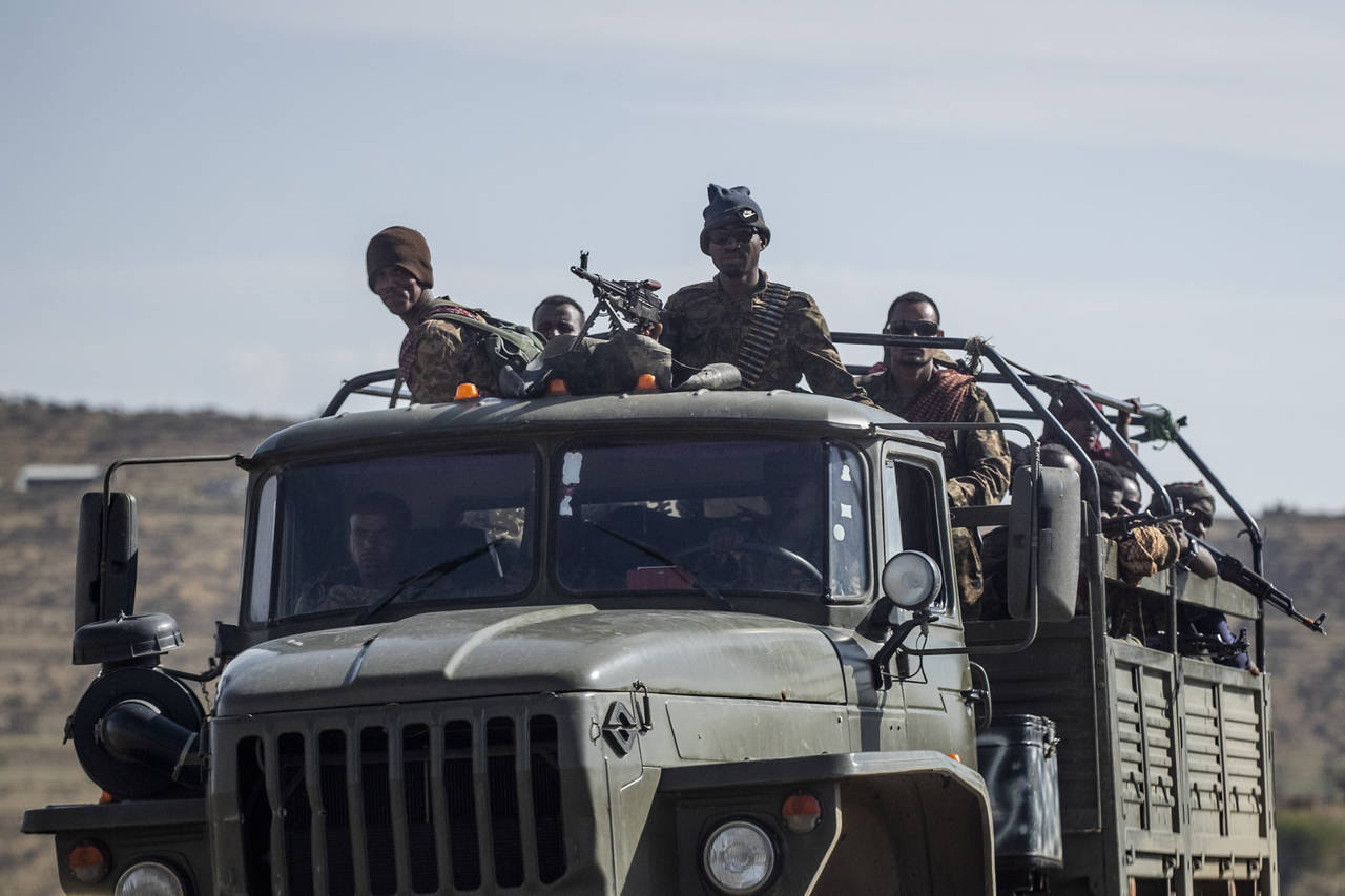 FILE - Ethiopian government soldiers ride in the back of a truck on a road near Agula, north of Mek...