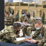 
              Students enlisted in the new Army prep course work together in barracks at Fort Jackson in Columbia, S.C., Friday, Aug. 26, 2022. The new course is an an effort to better prepare recruits for the demands of basic training. (AP Photo/Sean Rayford)
            