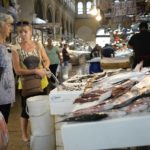 
              Two women shop at Varvakios fish market in central Athens, Greece, Friday, Aug. 19, 2022. Saturday's formal end of Greece's close budgetary supervision by European Union creditors closes an unwelcome chapter dating back to the painful bailout years. (AP Photo/Thanassis Stavrakis)
            