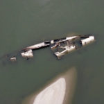 
              The wreckage of a WWII German warship is seen in the Danube river near Prahovo, Serbia, Monday, Aug. 29, 2022. The worst drought in Europe in decades has not only scorched farmland and hampered river traffic, it also has exposed a part of World War II history that had almost been forgotten. The hulks of dozens of German battleships have emerged from the mighty Danube River as its water levels dropped. (AP Photo/Darko Vojinovic)
            