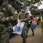 
              Security forces carry ballot boxes to a collection and tallying center in Nairobi, Kenya Wednesday, Aug. 10, 2022. Kenyans are waiting for the results of a close but calm presidential election in which the turnout was lower than usual. (AP Photo/Mosa'ab Elshamy)
            