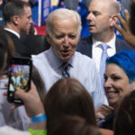 
              President Joe Biden greets supporters during a rally for the Democratic National Committee at Richard Montgomery High School, Thursday, Aug. 25, 2022, in Rockville, Md. (AP Photo/Alex Brandon)
            