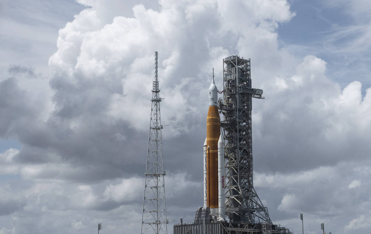 In this photo provided by NASA, NASA's Space Launch System (SLS) rocket with the Orion spacecraft a...