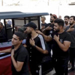 
              In this frame grab from video, coffins wrapped with the Iraqi flag of two fighters who were killed in clashes with Iraqi security forces in Baghdad's Green Zone, are brought to Imam Ali Shrine during their funeral, in Najaf, Iraq, Tuesday, Aug. 30, 2022. The fighters were among at least 30 people who have died in two days of unrest, according to officials. Those backing cleric Muqtada al-Sadr, who resigned suddenly Monday amid a political impasse, earlier stormed the Green Zone, once the stronghold of the U.S. military that's now home to Iraqi government offices and foreign embassies. (AP Photo)
            