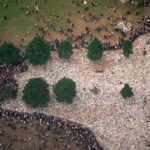 
              FILE - An aerial view of flowers and other mementos that have been left by mourners in honour of Princess Diana, at Kensington Palace in London, Friday, Sept. 5, 1997. It was a warm Saturday evening and journalists had gathered at a Paris restaurant to enjoy the last weekend of summer. At sometime past midnight, phones around the table began to ring all at once. News desks were contacting reporters and photographers to alert them that Princess Diana’s car had crashed in the Pont de l’Alma tunnel in Paris. That's how the news unfolded in the early hours of Aug. 31, 1997.  (AP Photo/Jerome Delay, FIle)
            