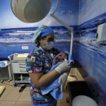 
              Namunkura Fernandez Aucapan is taken by a nurse to be tested after being born at the San Jose de Osorno Base Hospital in Osorno, Chile, Saturday, Aug. 20, 2022. The largest public hospital in Osorno is finding new ways to incorporate Indigenous health care practices, such as having a machi, or Mapuche spiritual guide, help with delivery. (AP Photo/Luis Hidalgo)
            