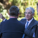 
              Federal Reserve Chair Jerome Powell, center, takes a coffee break with attendees of the central bank's annual symposium at Jackson Lake Lodge in Grand Teton National Park Friday, Aug. 26, 2022. in Moran, Wyo. (AP Photo/Amber Baesler)
            