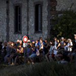 
              People and media gather to see firefighters and members of a search and rescue team conduct a mission to move a Beluga whale that strayed into France's Seine river to a saltwater basin, near the Notre-Dame-de-la-Garenne lock in Saint-Pierre-la-Garenne, west of Paris, France, Tuesday, Aug. 9, 2022. (Benoit Tessier / Pool via AP)
            