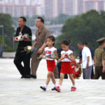 
              Children carry flowers to the statues of President Kim Il Sung and Chairman Kim Jong Il on Mansu Hill to commemorate the 77th anniversary of Korea's Liberation in Pyongyang, North Korea, Monday, Aug. 15, 2022. (AP Photo/Cha Song Ho)
            