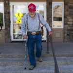 
              Horton Spitzer, a 89-year-old retired rancher, wearing a "Make America Great" hat,  walks down the steps of a polling place after he decided to vote on the day of the primary election in Jackson, Wyo., Monday, Aug. 15, 2022. Wyoming holds its Republican primary election Tuesday. (AP Photo/Jae C. Hong)
            
