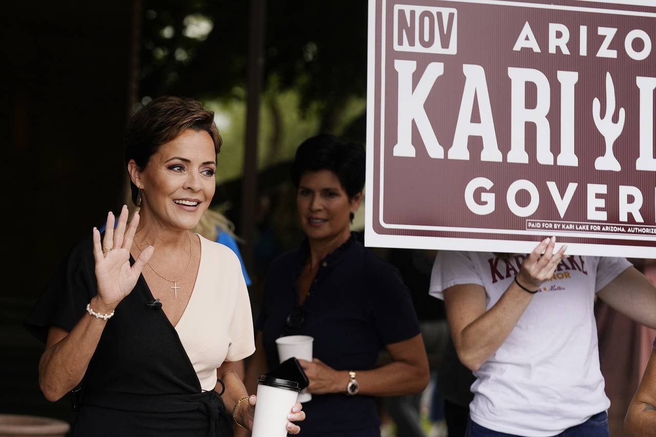 Kari Lake, Republican candidate for Arizona governor, waves to supporters prior to speaking at a ne...