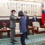 
              In this photo released by the Taiwan Presidential Office, Taiwan's President Tsai Ing-wen, center, bumps elbows with a member of the Japanese delegation led by Keiji Furuya, third from left, an ultra-conservative who heads a Japan-Taiwan parliamentarians group, in Taipei, Taiwan on Tuesday, Aug. 23, 2022. Taiwan's president invoked an armed conflict from 1958 as an example of the island's resolve to defend itself while she met Tuesday with more foreign visitors amid the highest tensions with China in decades. (Taiwan Presidential Office via AP)
            