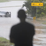 
              A swamped car sits in flood waters covering a closed highway in Dallas, Monday, Aug. 22, 2022. (AP Photo/LM Otero)
            