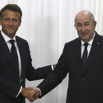 
              French President Emmanuel Macron, left, shakes hands with Algerian President Abdelmajid Tebboune before their talks, Thursday, Aug. 25, 2022 in Algiers. French President Emmanuel Macron is in Algeria for a three-day official visit aimed at addressing two major challenges: boosting future economic relations while seeking to heal wounds inherited from the colonial era, 60 years after the North African country won its independence from France. (AP Photo/Anis Belghoul)
            