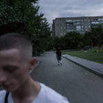 
              Roman Kovalenko, 19, left, walks away after visiting his friend, Oleksandr Pruzhyna, 18, at his apartment complex for their weekly get together in Kramatorsk, Donetsk region, eastern Ukraine, Friday, Aug. 12, 2022. The two became close this winter when Russia's invasion began and now they are the only friends that each other have left in the city. (AP Photo/David Goldman)
            