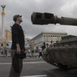 
              People visit an avenue where destroyed Russian military vehicles have been displayed in Kyiv, Ukraine, Saturday, Aug. 20, 2022. Drawing the attention of large numbers of pedestrians and amateur snappers on Saturday in downtown Kyiv a large column of burned out and captured Russian tanks and infantry carriers were displayed on the central Khreshchatyk boulevard. (AP Photo/Andrew Kravchenko)
            