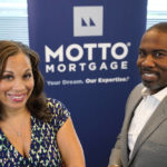 
              The husband and wife team of Kelly Jackson, right, and Davina Arceneaux stand for a portrait at their Motto Mortgage office Thursday, July 28, 2022, in Oakbrook Terrace, Ill. (AP Photo/Charles Rex Arbogast)
            